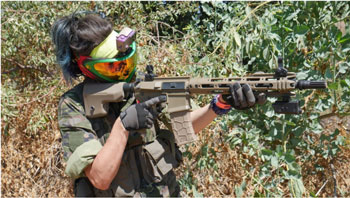 AIrsoft player shooting their carbine in a match